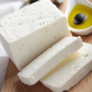 Cheese next to olive oil